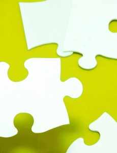 Assembling Blank Puzzle Pieces on Red Surface